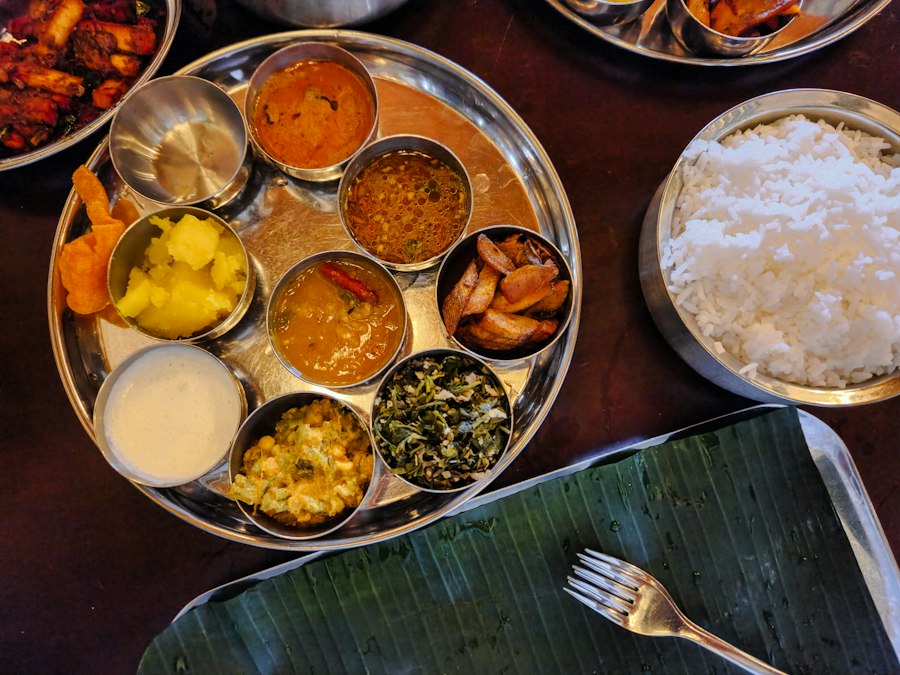 A traditional thali served with side dishes on a banana leaf